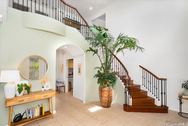 1098 Kuekue St, Honolulu, HI 96825 - stairway with tile patterned flooring, arched walkways, a high ceiling, and recessed lighting