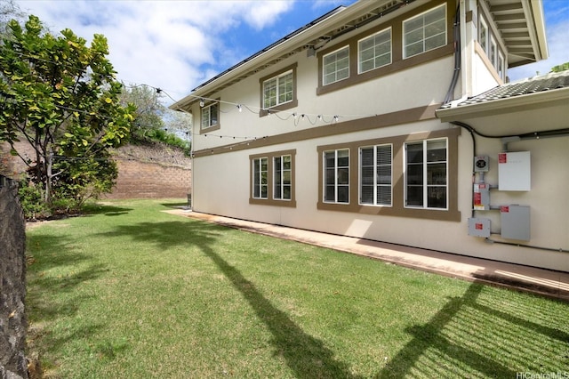 1098 Kuekue St, Honolulu, HI 96825 - rear view of house featuring a yard and stucco siding
