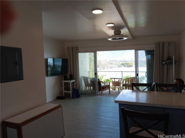 dining space featuring electric panel and wood finished floors