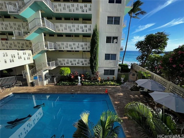 view of swimming pool with a water view