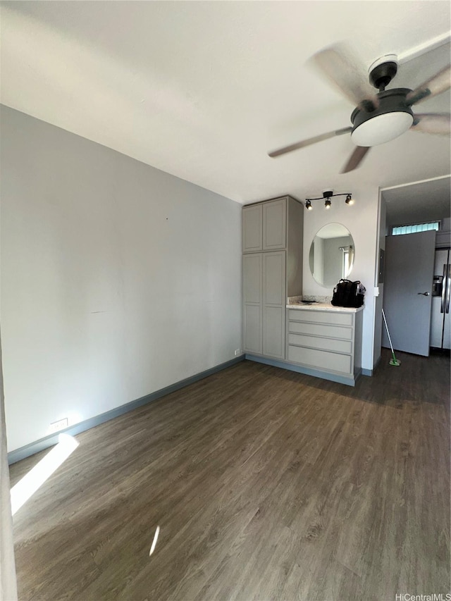 84-265 Farrington Hwy Unit 206, Waianae, HI 96792 - unfurnished living room featuring ceiling fan, dark wood-style flooring, and baseboards