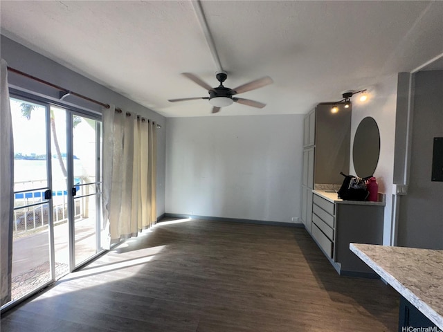 84-265 Farrington Hwy Unit 206, Waianae, HI 96792 - interior space featuring dark wood finished floors, ceiling fan, and baseboards