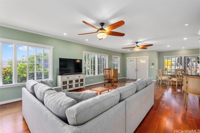 living room with crown molding and hardwood / wood-style flooring