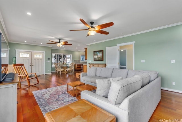 living room with hardwood / wood-style flooring and ornamental molding