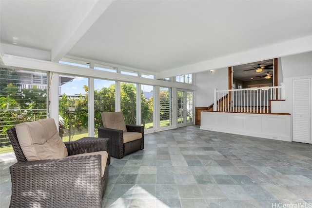 sunroom / solarium with ceiling fan and beam ceiling