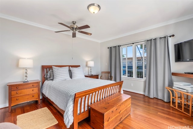 bedroom with hardwood / wood-style floors and ornamental molding