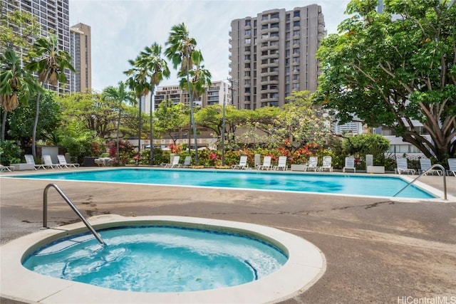 view of swimming pool with a community hot tub