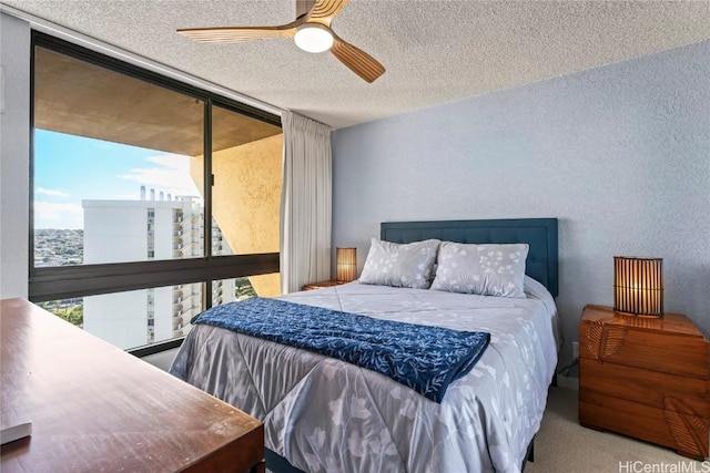 bedroom with floor to ceiling windows, a textured ceiling, carpet floors, ceiling fan, and access to exterior