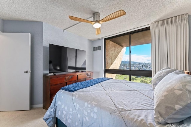 bedroom featuring a wall of windows, ceiling fan, carpet flooring, a textured ceiling, and access to outside