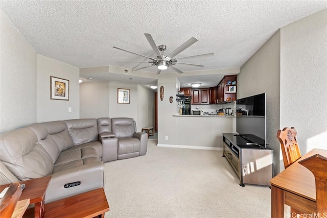 carpeted living room with a textured ceiling and ceiling fan