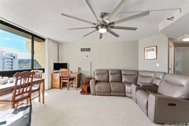 living room with light carpet, a textured ceiling, and ceiling fan