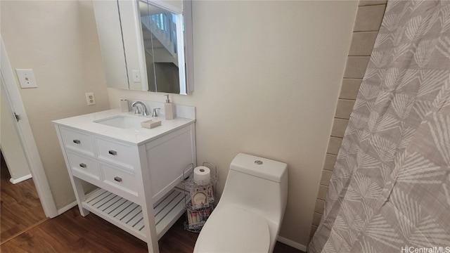 bathroom featuring hardwood / wood-style flooring, vanity, and toilet