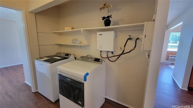 clothes washing area featuring washing machine and clothes dryer, dark hardwood / wood-style floors, a wall mounted AC, and electric panel