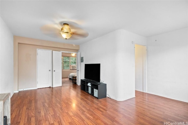 living room featuring hardwood / wood-style flooring and ceiling fan