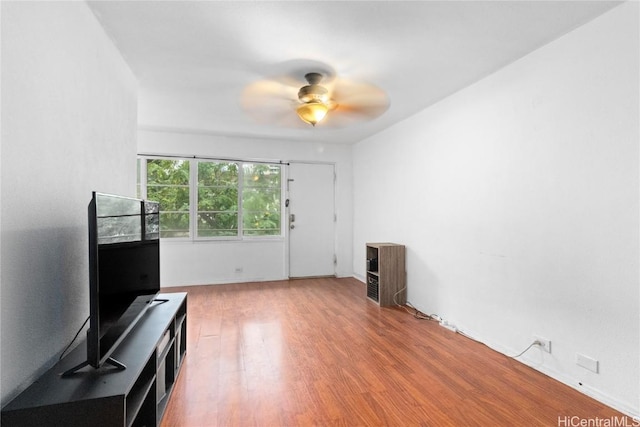 unfurnished living room featuring hardwood / wood-style floors and ceiling fan