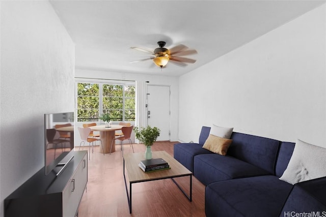 living room with light wood-style flooring and a ceiling fan