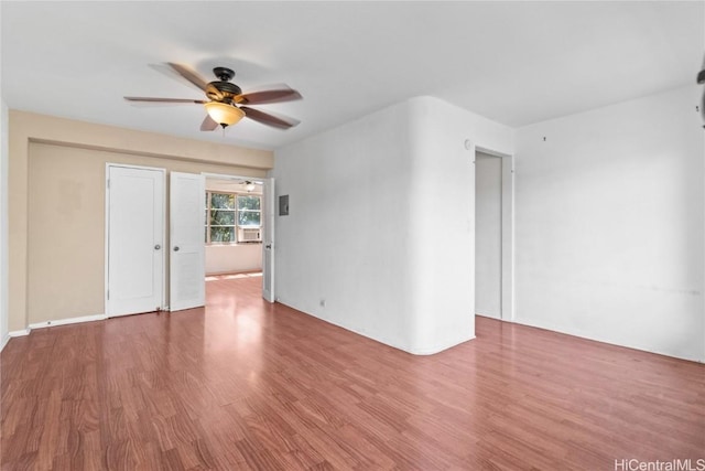 unfurnished room with a ceiling fan and wood finished floors