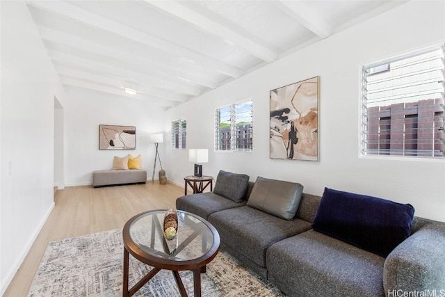 living area featuring beamed ceiling, wood finished floors, and baseboards