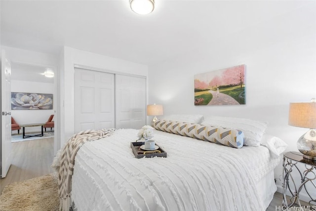 bedroom with a closet and light wood-style flooring