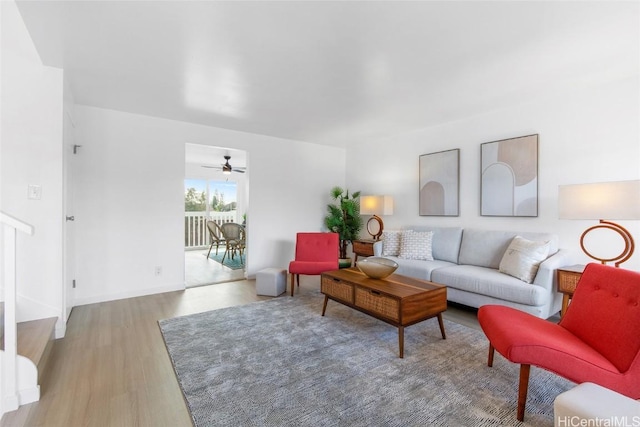 living room with light wood-type flooring and ceiling fan