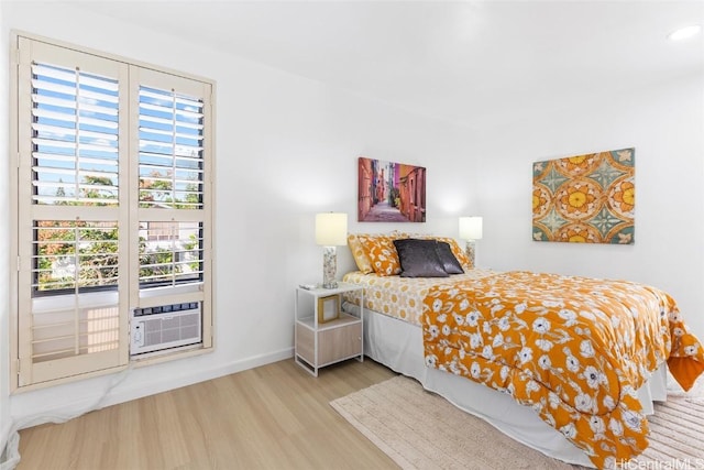 bedroom with light wood-style flooring and baseboards