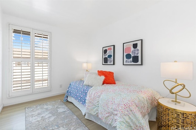 bedroom featuring light wood-type flooring and baseboards