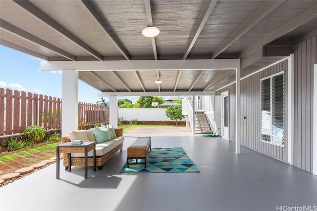 view of patio featuring a fenced backyard, outdoor lounge area, and stairway