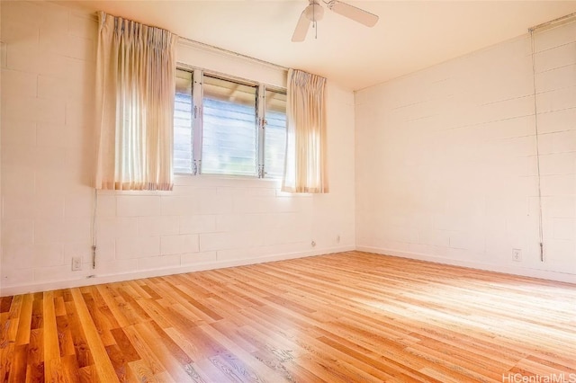 empty room featuring hardwood / wood-style flooring and ceiling fan