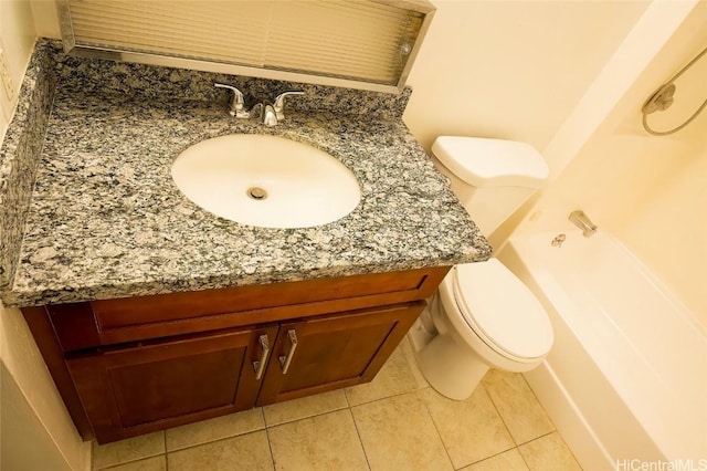 bathroom featuring vanity, tile patterned flooring, and toilet