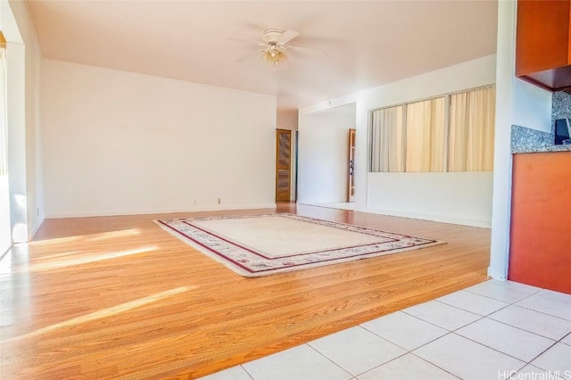 empty room featuring ceiling fan and light hardwood / wood-style floors