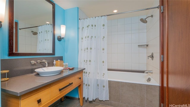 bathroom with tile patterned flooring, vanity, and shower / tub combo