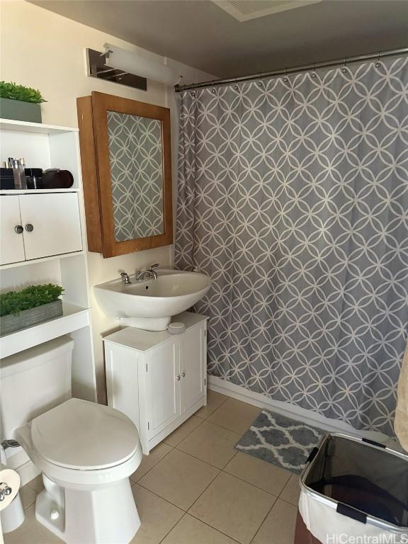 bathroom featuring tile patterned flooring, vanity, and toilet