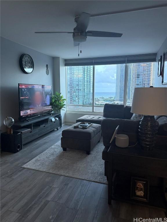 living room featuring ceiling fan and hardwood / wood-style floors