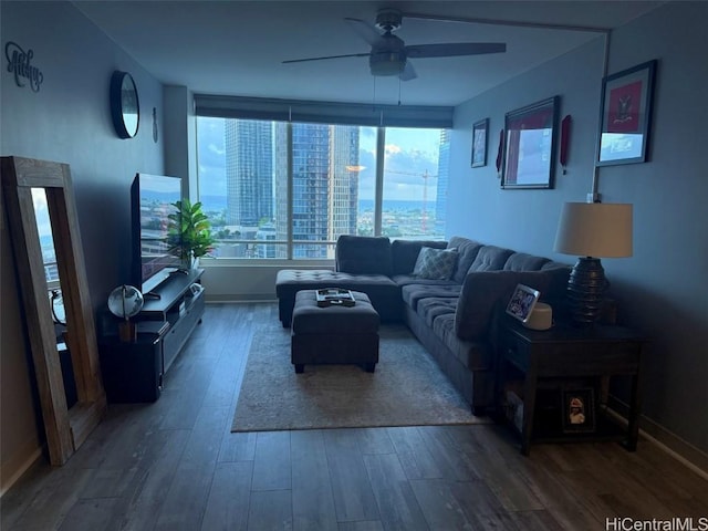 living room featuring wood-type flooring and ceiling fan