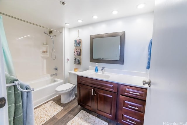 full bathroom featuring vanity, hardwood / wood-style flooring, toilet, and shower / bathing tub combination