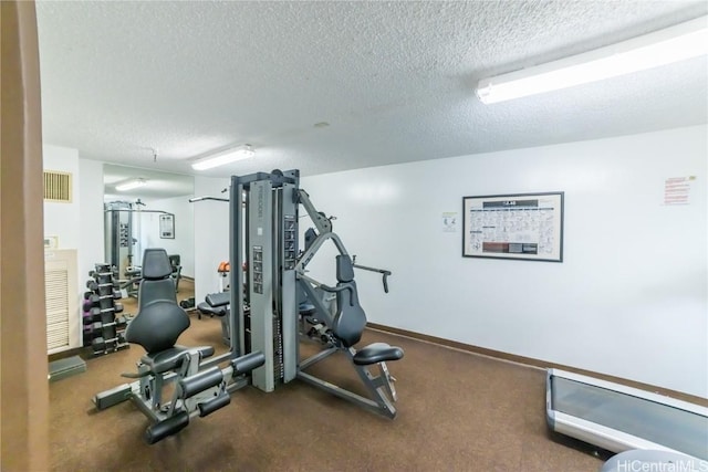 exercise room featuring a textured ceiling