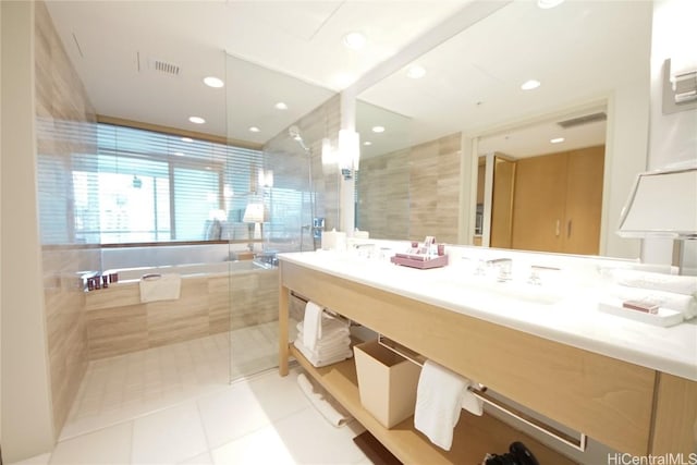 bathroom featuring tile patterned floors, shower with separate bathtub, and sink