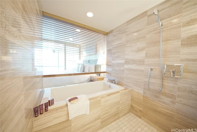 bathroom featuring separate shower and tub