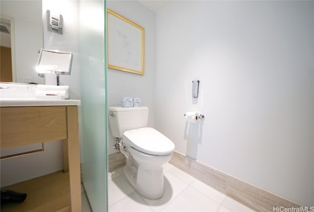 bathroom with vanity, tile patterned floors, and toilet