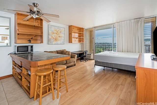 bedroom featuring access to outside and light hardwood / wood-style floors