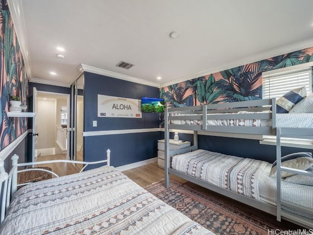 bedroom featuring hardwood / wood-style floors and ornamental molding