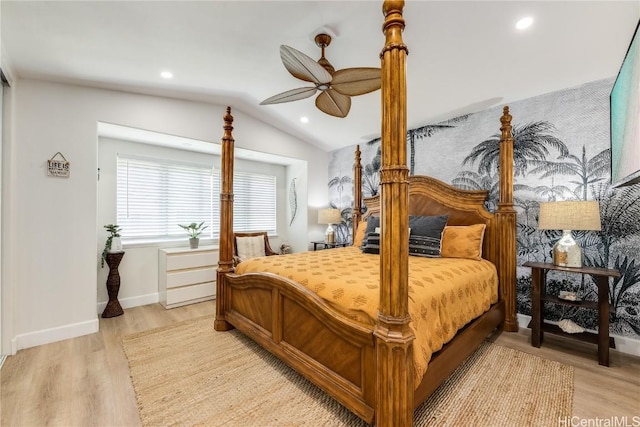 bedroom with ceiling fan, lofted ceiling, and light hardwood / wood-style flooring