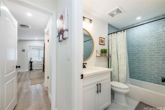 full bathroom featuring vanity, shower / tub combo, wood-type flooring, and toilet