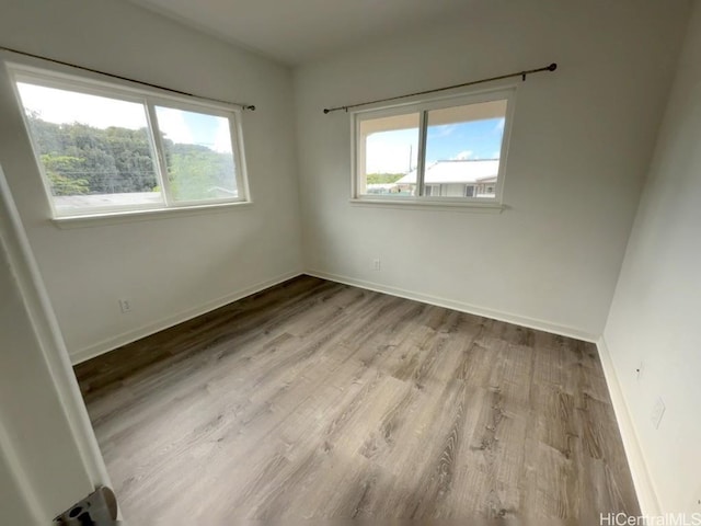 unfurnished room with plenty of natural light and light hardwood / wood-style floors