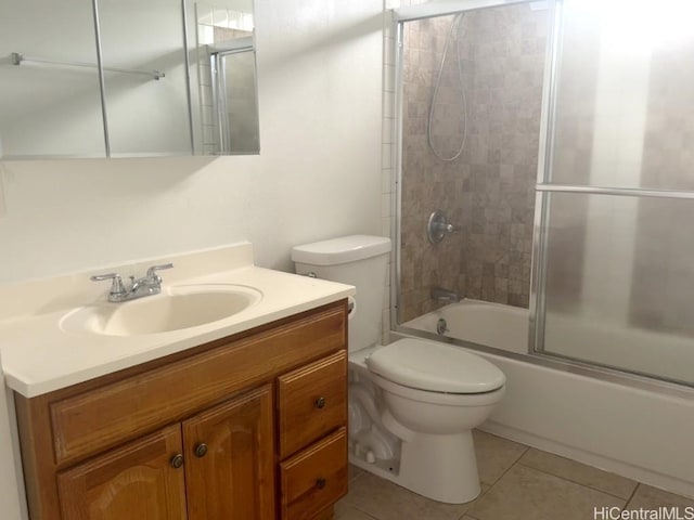 full bathroom featuring tile patterned flooring, vanity, combined bath / shower with glass door, and toilet