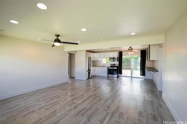 unfurnished living room with light hardwood / wood-style flooring and ceiling fan