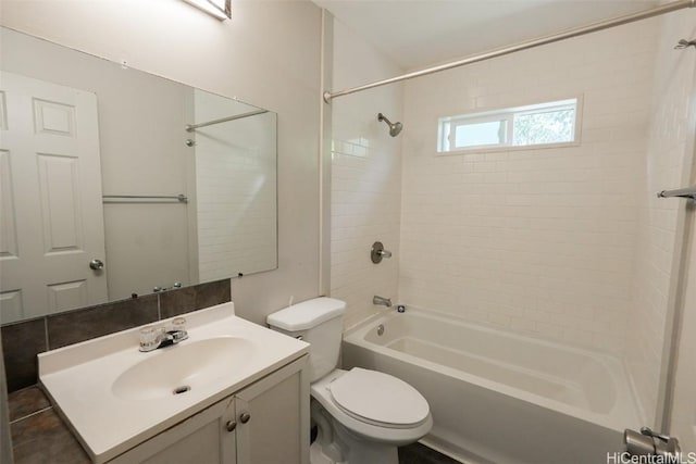 full bathroom featuring vanity, toilet, and tiled shower / bath