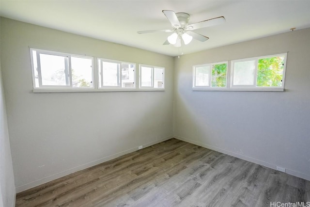 unfurnished room with ceiling fan and light wood-type flooring