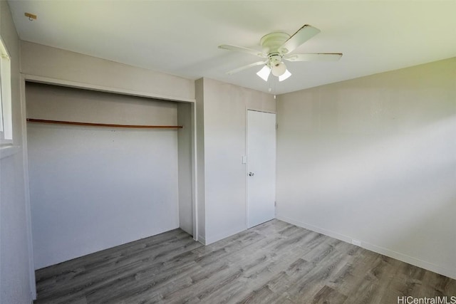 unfurnished bedroom with ceiling fan, light hardwood / wood-style floors, and a closet