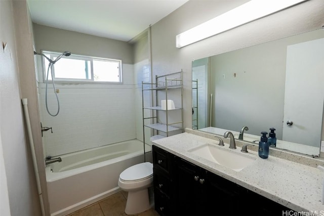 full bathroom with vanity, tiled shower / bath, tile patterned floors, and toilet